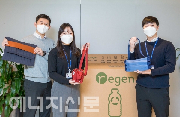 ▲ 효성티앤씨 직원들이 사내 페트병 수거함 앞에서 친환경 섬유 리젠으로 만든 가방을 선보이고 있다.