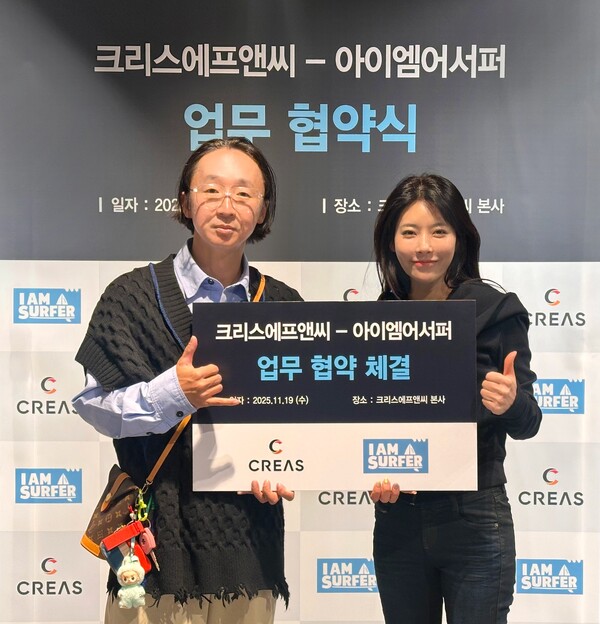 ▲ 크리스에프앤씨 우윤주 이사(왼쪽)와 아이엠어서퍼 전성곤(곤대장) 대표(오른쪽)가 업무협약을 체결하며 기념촬영을 하고 있다.